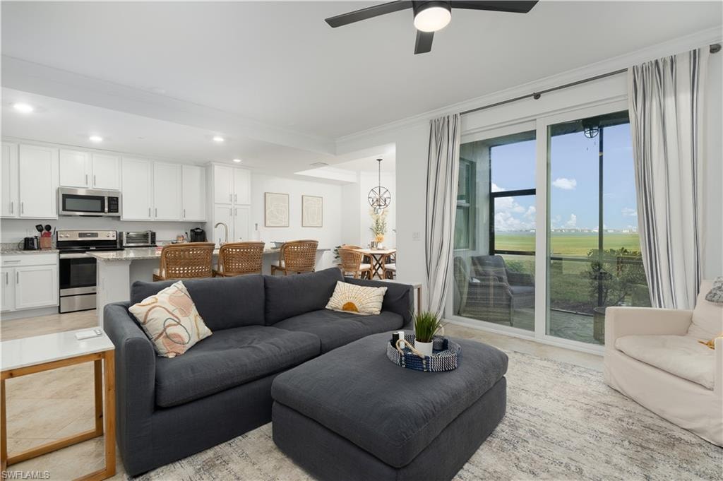 Living area with a toaster, ceiling fan, crown molding, and recessed lighting