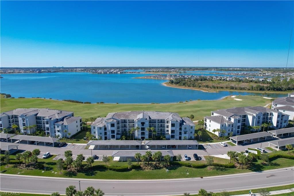 Birds eye view of property with a water view