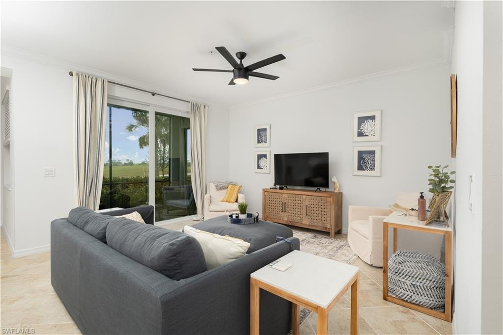 Living room with crown molding, baseboards, and ceiling fan