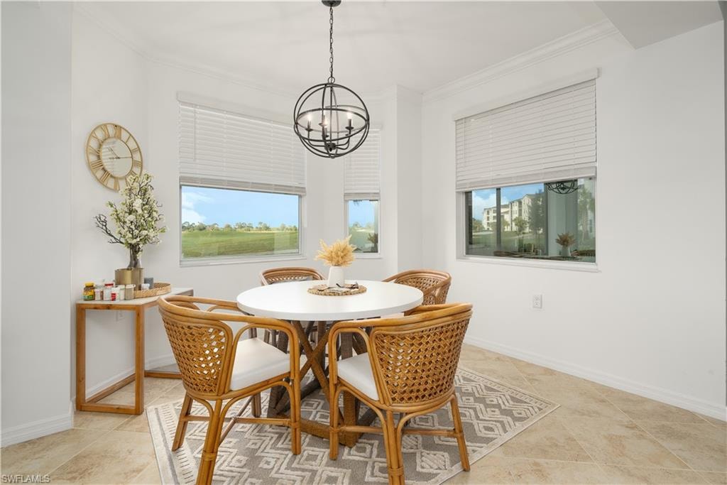 Dining room with a chandelier, crown molding, and baseboards