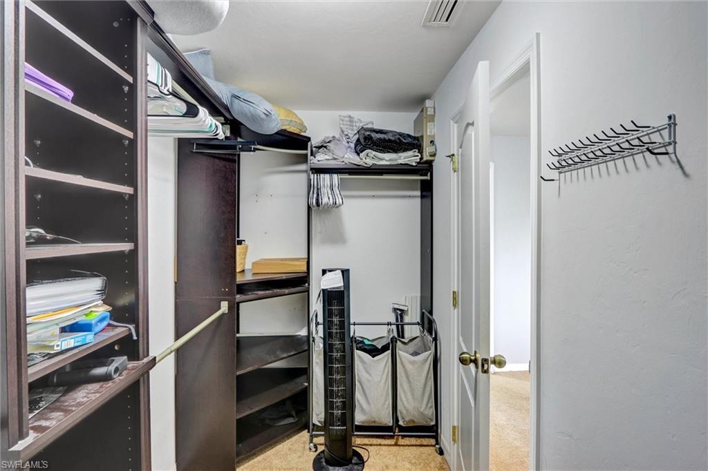 Walk in closet featuring light carpet