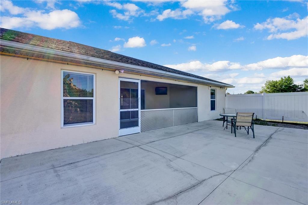 Back of house featuring stucco siding, a patio, and outdoor dining area