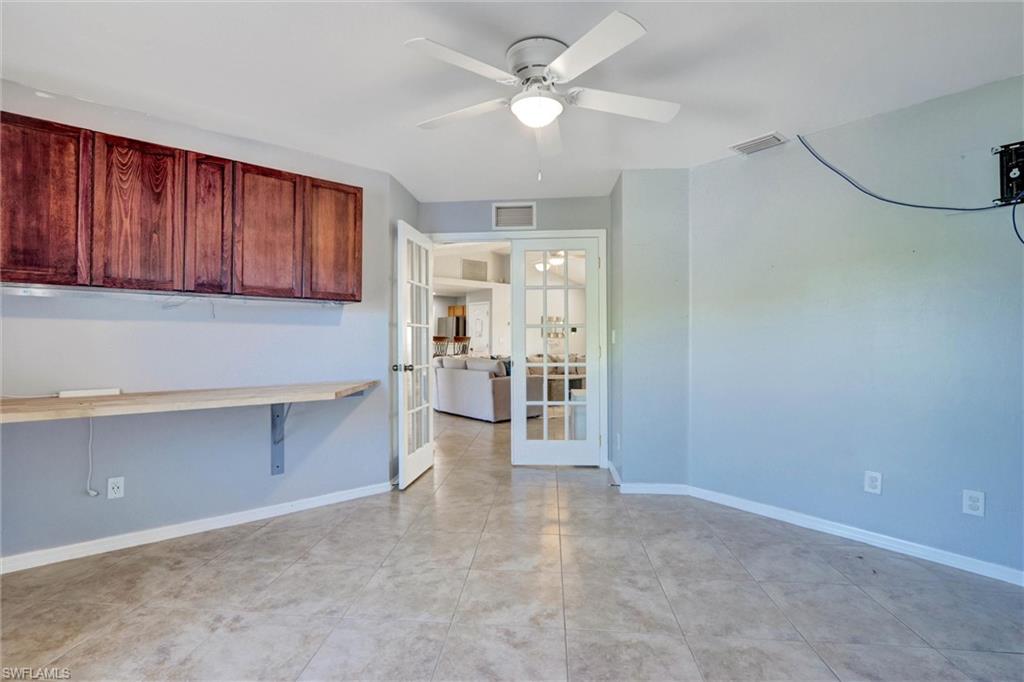 DEN / FLEX SPACE featuring french doors and ceiling fan