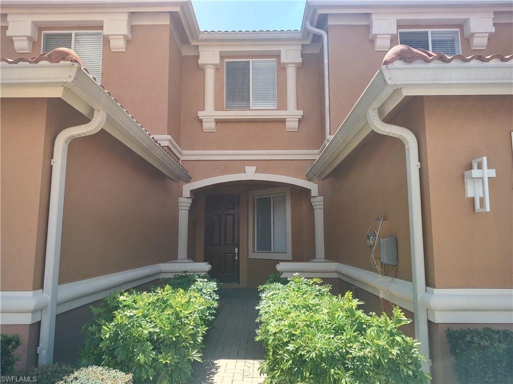 Doorway to property with stucco siding