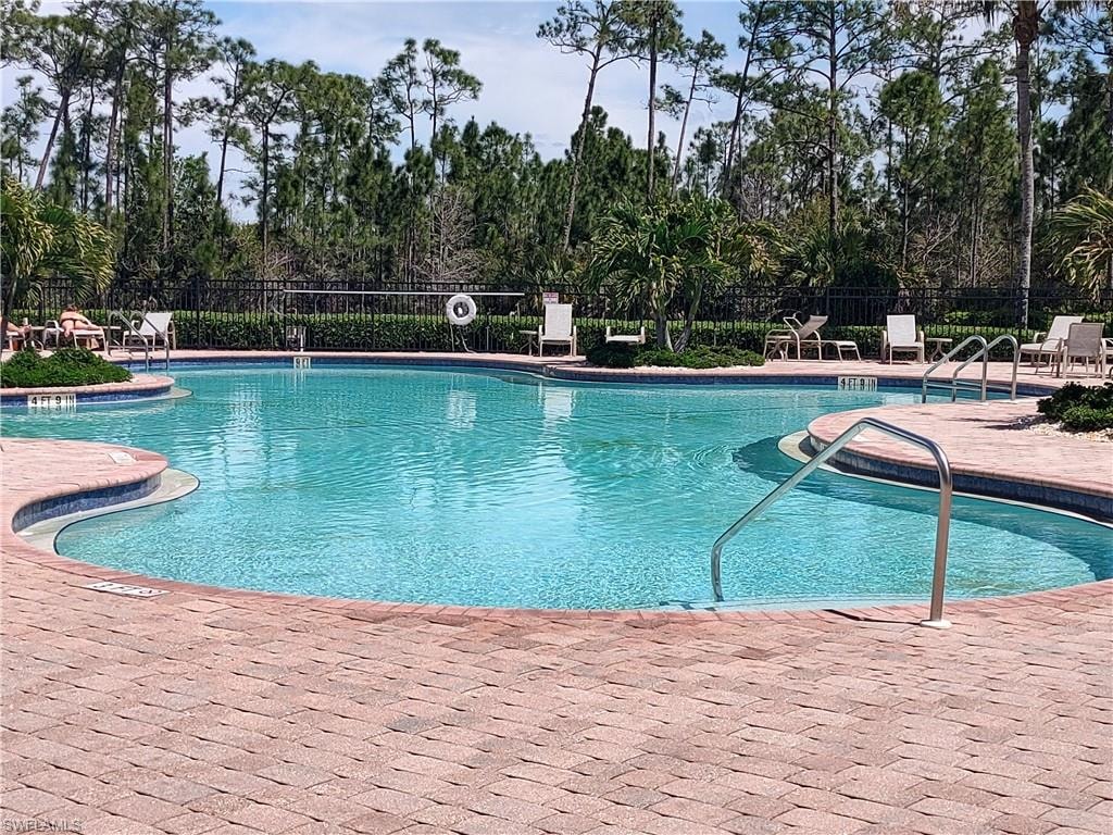 Community pool with a patio