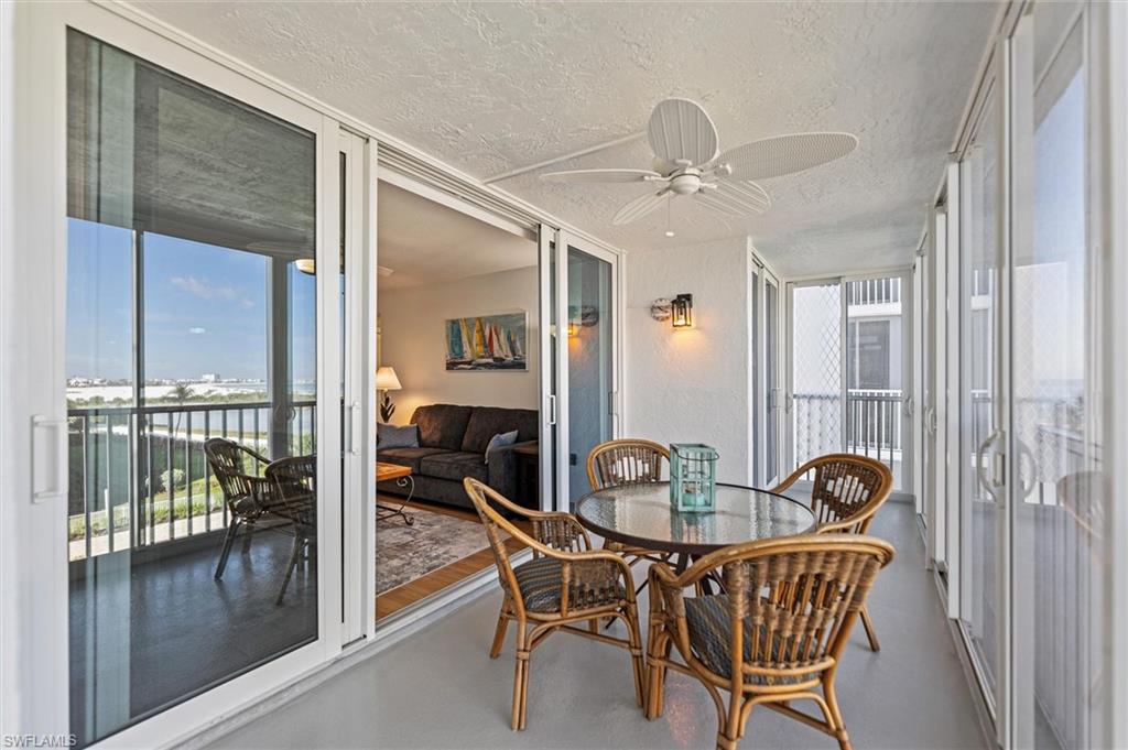 Sunroom featuring floor to ceiling windows, a textured ceiling, and finished concrete flooring