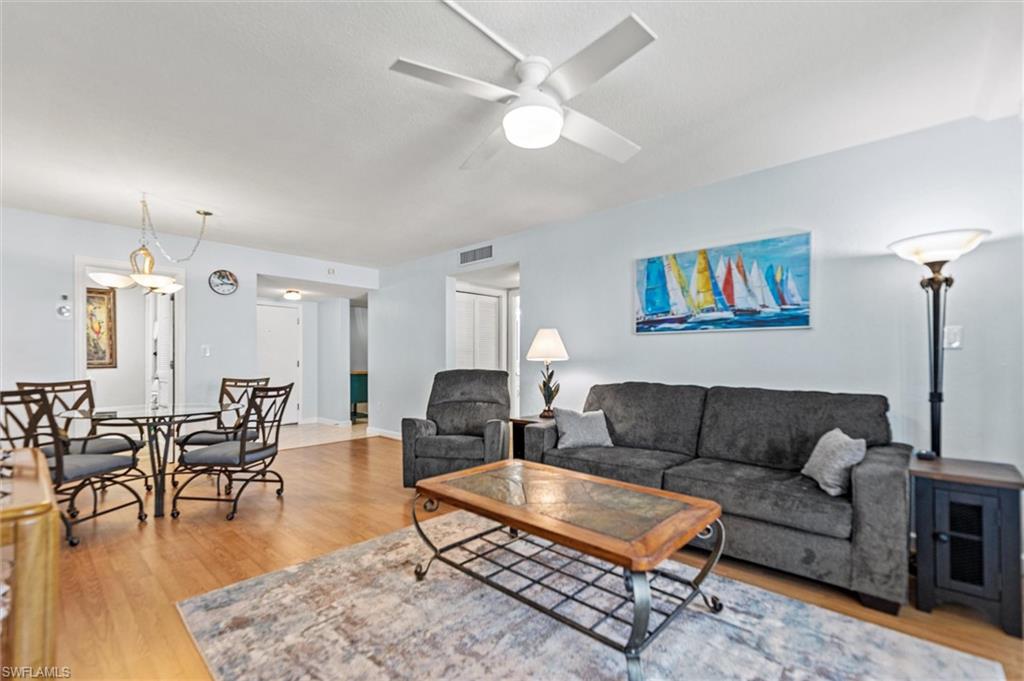 Living room featuring light wood-style flooring and ceiling fan