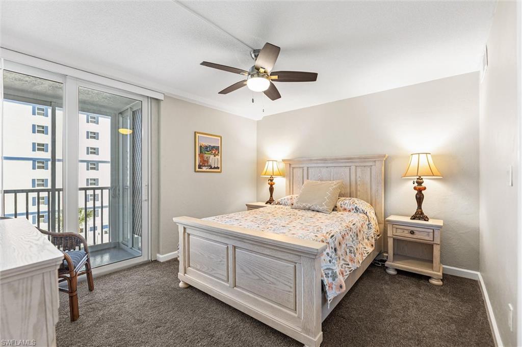 Bedroom with access to outside, a ceiling fan, dark carpet, and ornamental molding