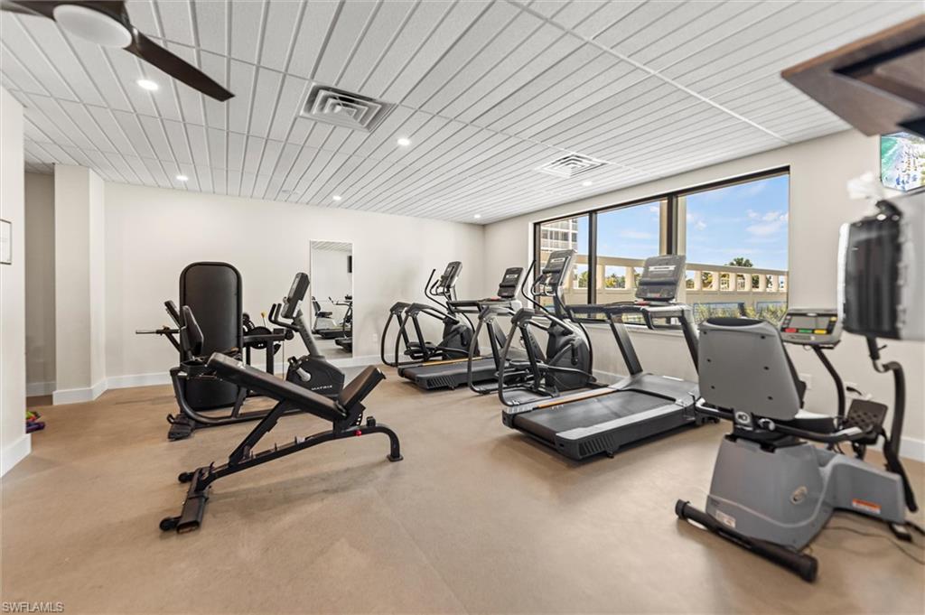 Gym with a ceiling fan and recessed lighting