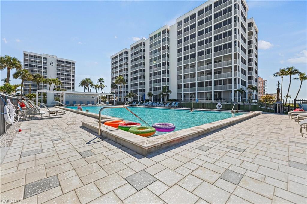 Community pool with a patio