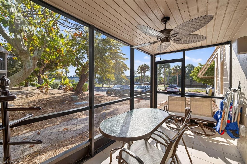 Sunroom with a ceiling fan and outdoor dining area