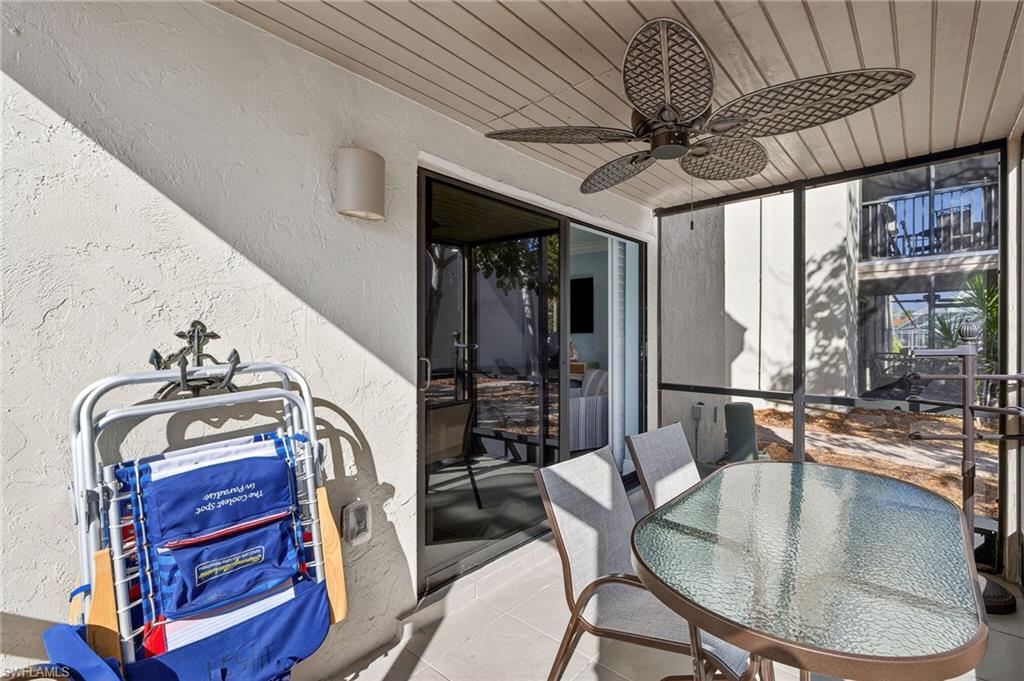 Sunroom featuring ceiling fan, a patio, and outdoor dining area
