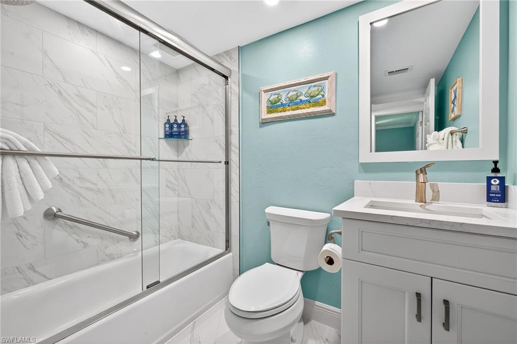 Full bath featuring vanity and enclosed tub / shower combo