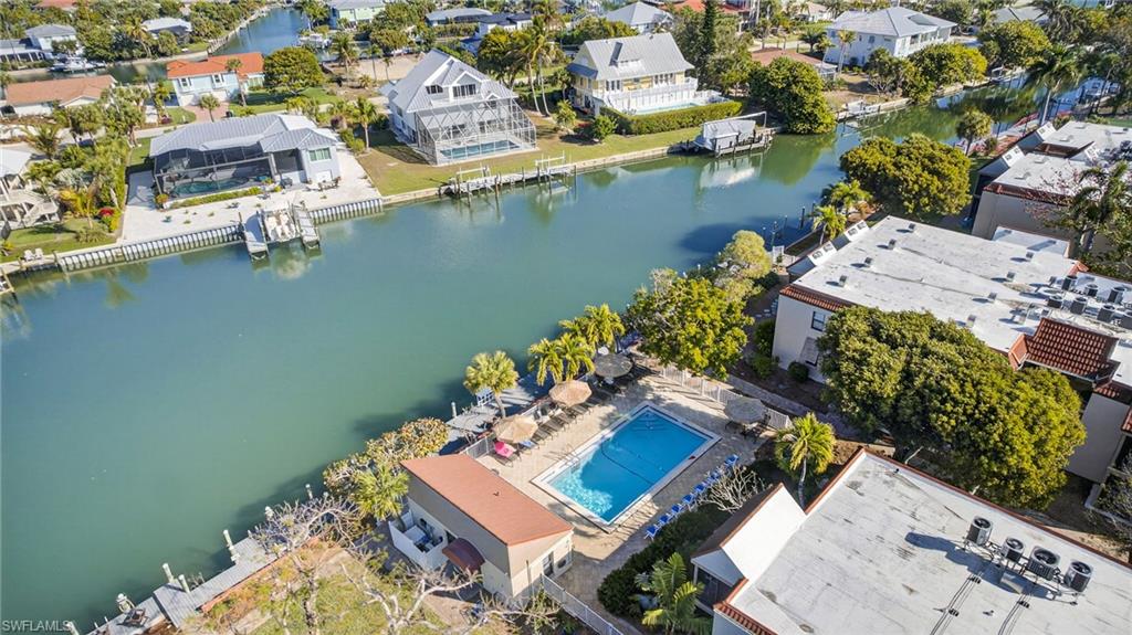 Aerial perspective of suburban area featuring a nearby body of water