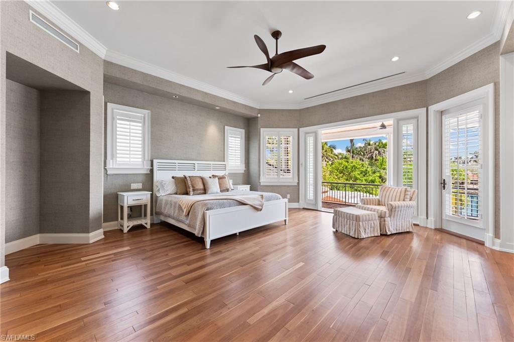 Bedroom with access to outside, baseboards, and hardwood / wood-style floors