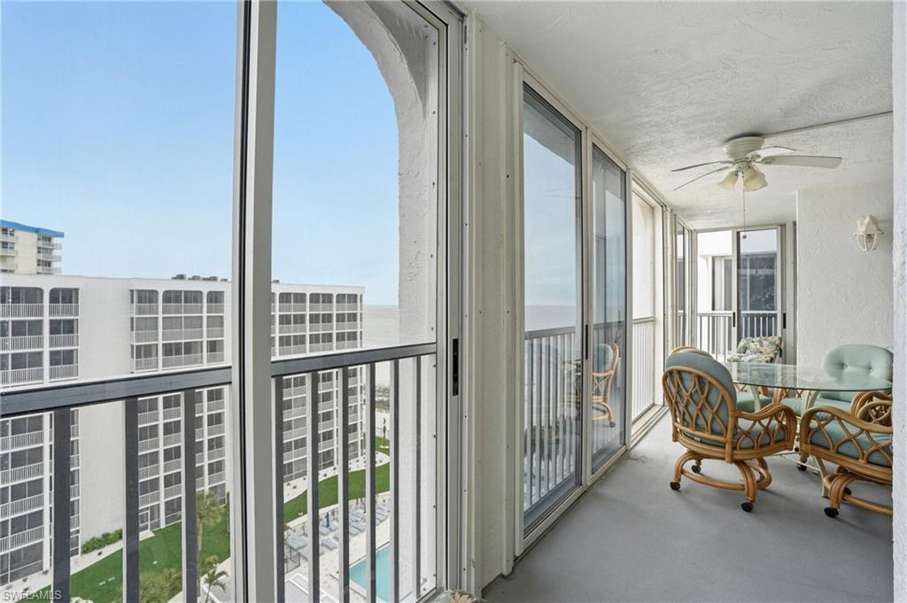 Balcony overlooks beach and pool