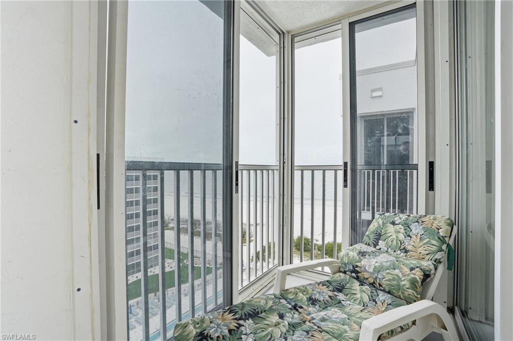 Balcony overlooks beach and pool
