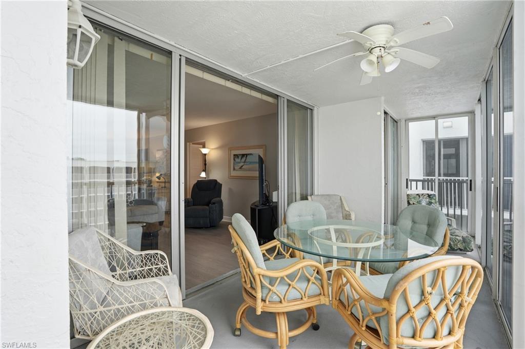 Balcony overlooks beach and pool