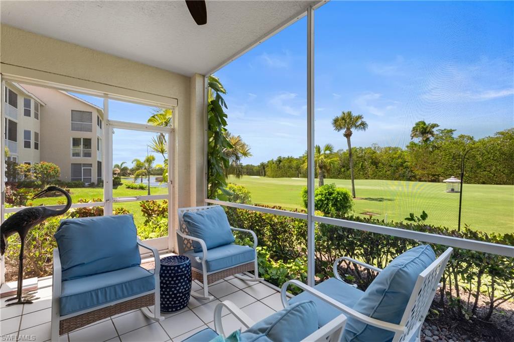 Sunroom / solarium featuring golf course view and a ceiling fan