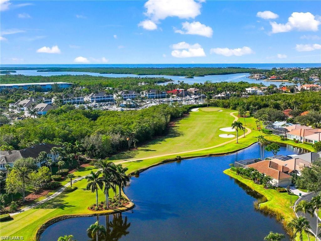 Drone / aerial view featuring a water view, view of golf course, and a residential view