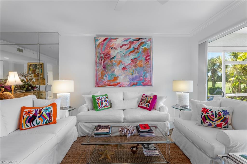 Living room featuring crown molding and visible vents