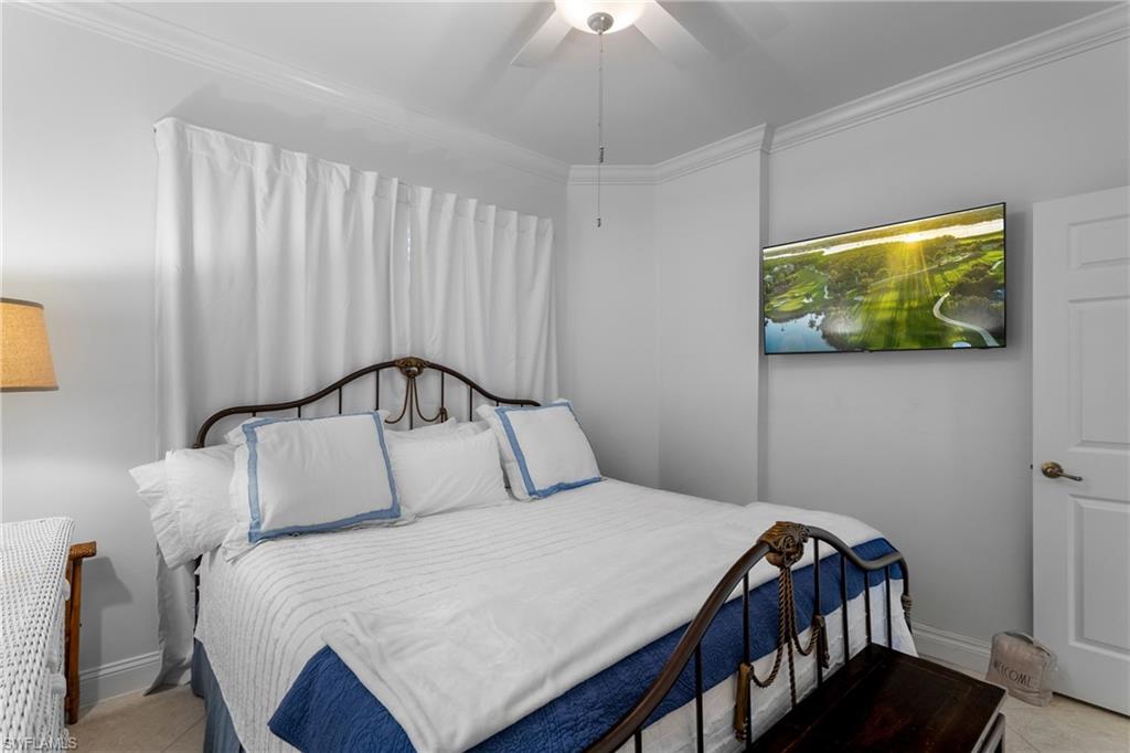 Bedroom with crown molding, baseboards, a ceiling fan, and tile patterned floors
