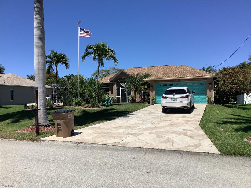 Front of home with beautiful Royal Palms