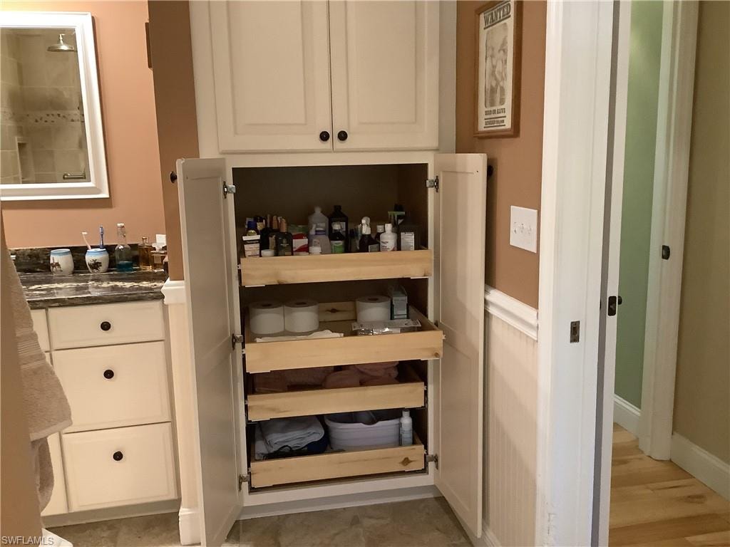 Master bath with large closet with pull-out drawers