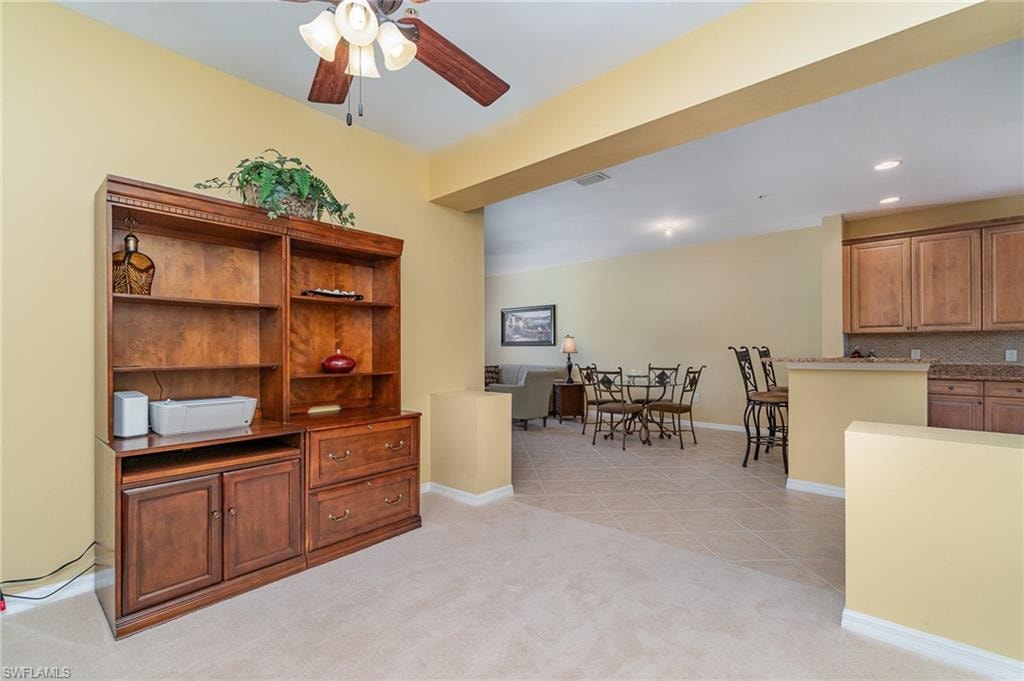 Office space featuring ceiling fan and light carpet