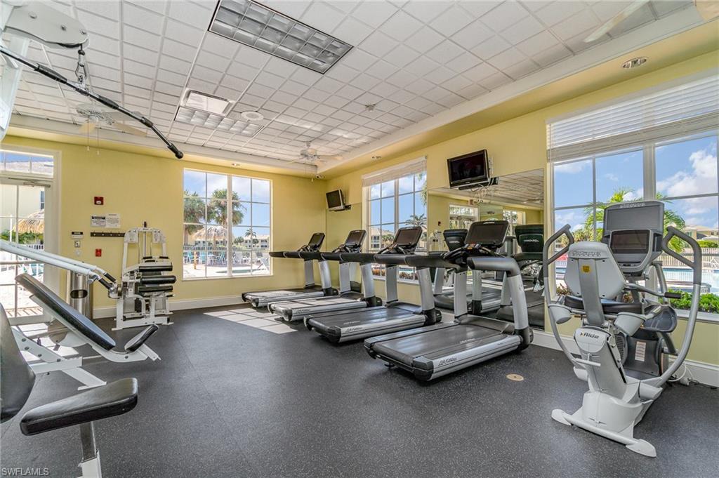 Workout area featuring a paneled ceiling and ceiling fan