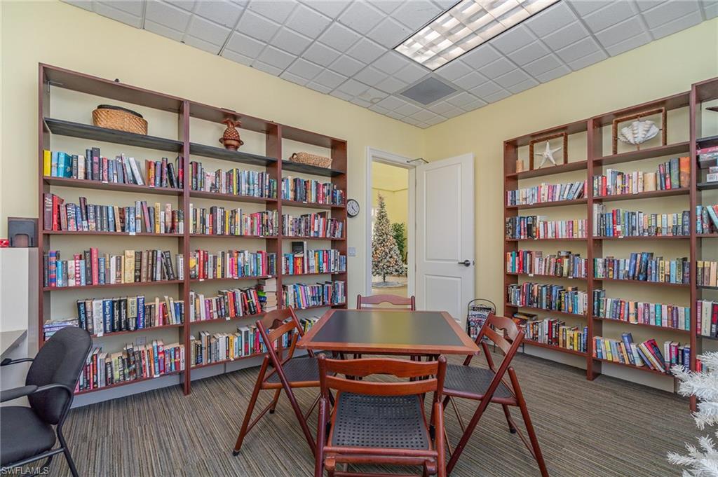 Carpeted office space featuring a drop ceiling