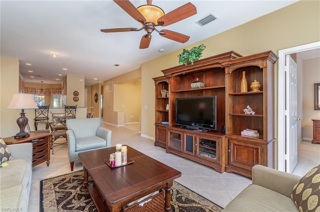 Tiled living room featuring ceiling fan