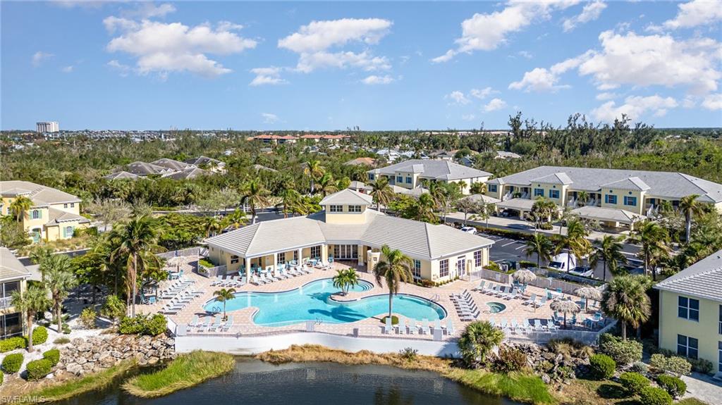 Birds eye view of property with a water view
