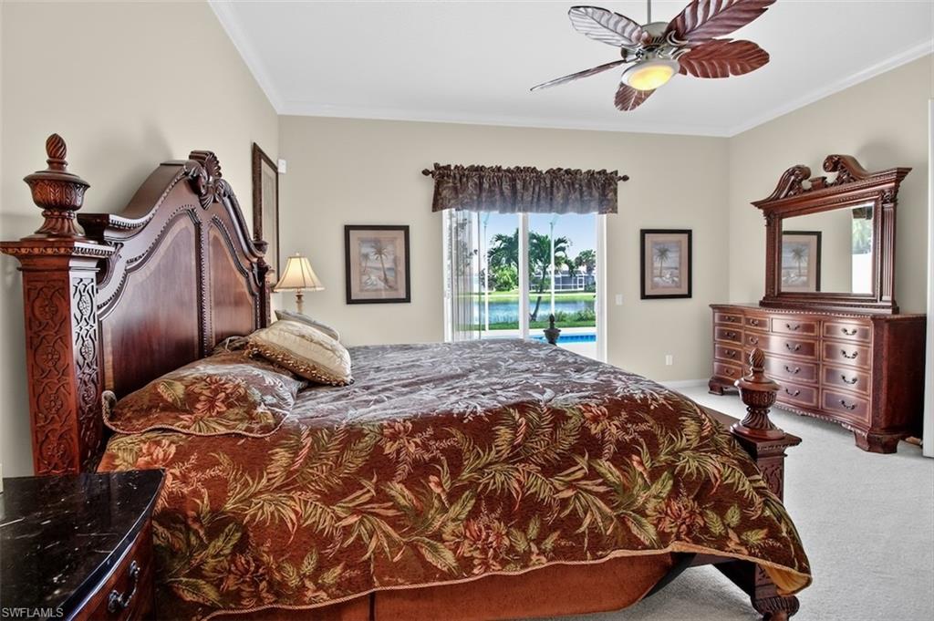 Bedroom with access to exterior, carpet, ceiling fan, and crown molding