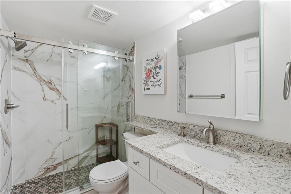 Full bath featuring vanity and a marble finish shower - Virtually Edited Image