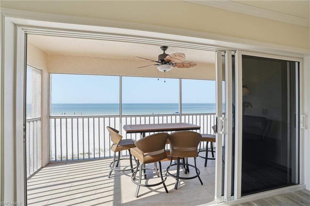 Sunroom with view of water and beach - Virtually Edited Image