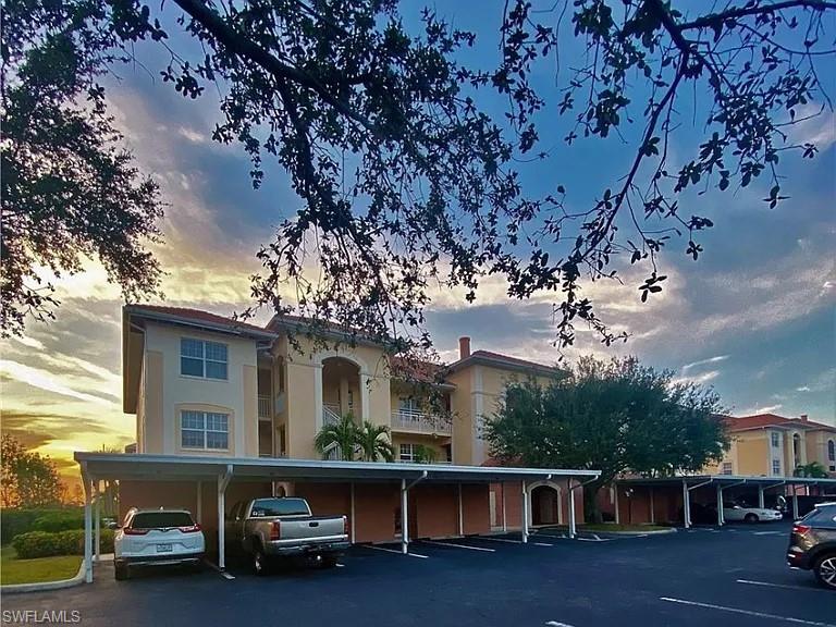 View of property featuring covered parking