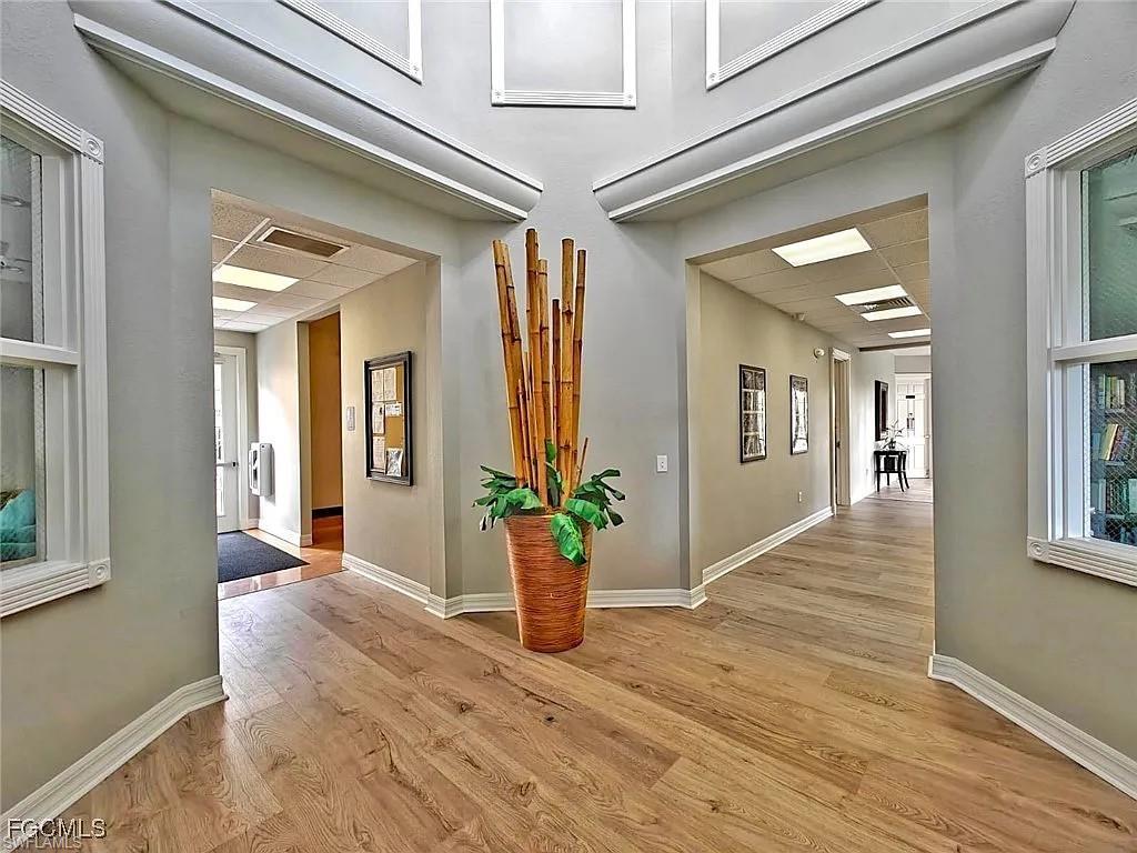 Hallway with light wood-style flooring and baseboards