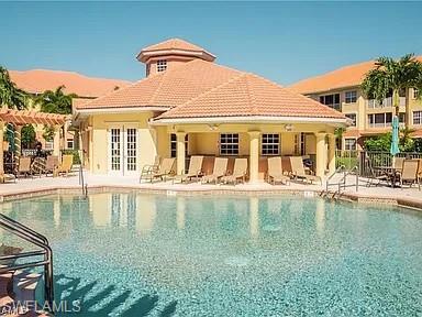 Community pool featuring a patio and a pergola