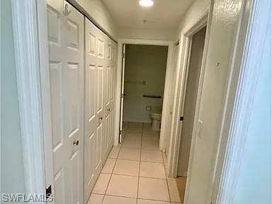 Hallway featuring light tile patterned flooring