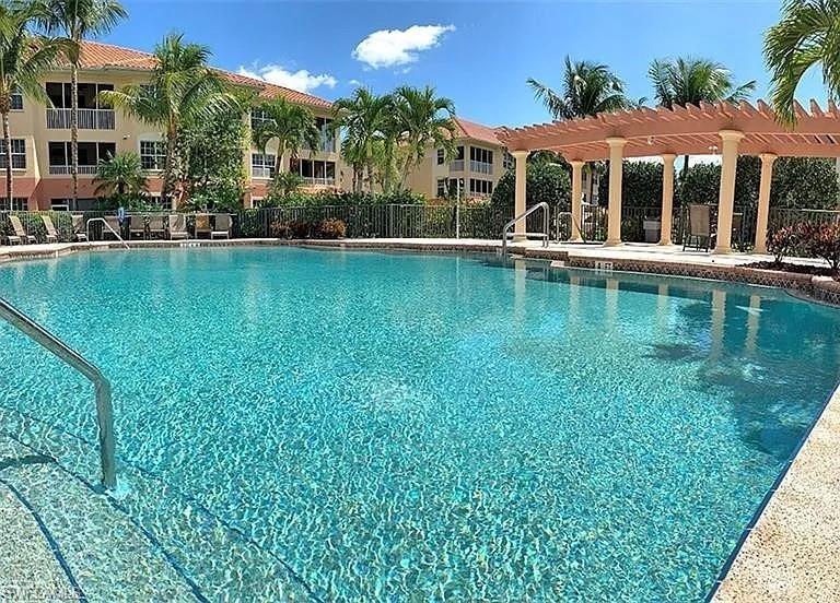 Community pool with a pergola and a patio area