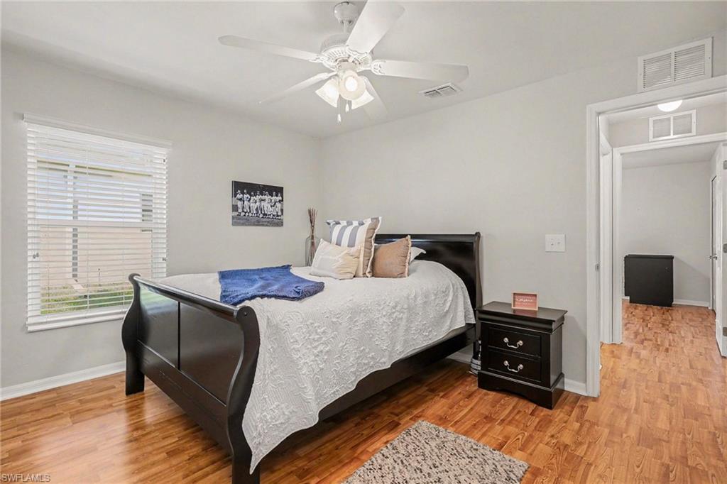 Bedroom with light wood-style floors and ceiling fan