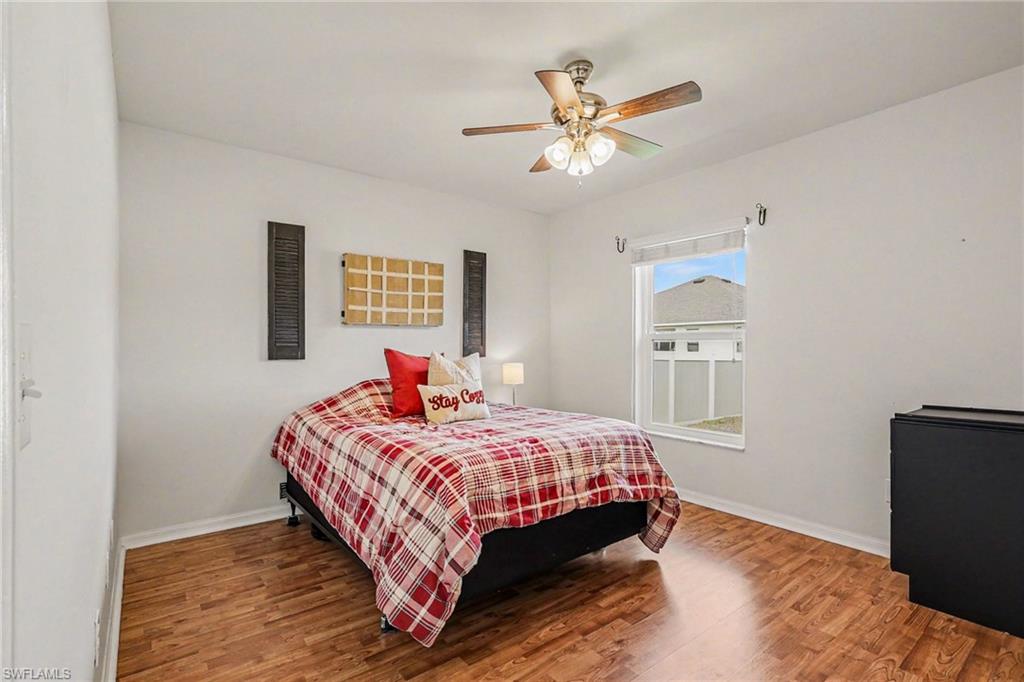 Bedroom with wood finished floors and ceiling fan