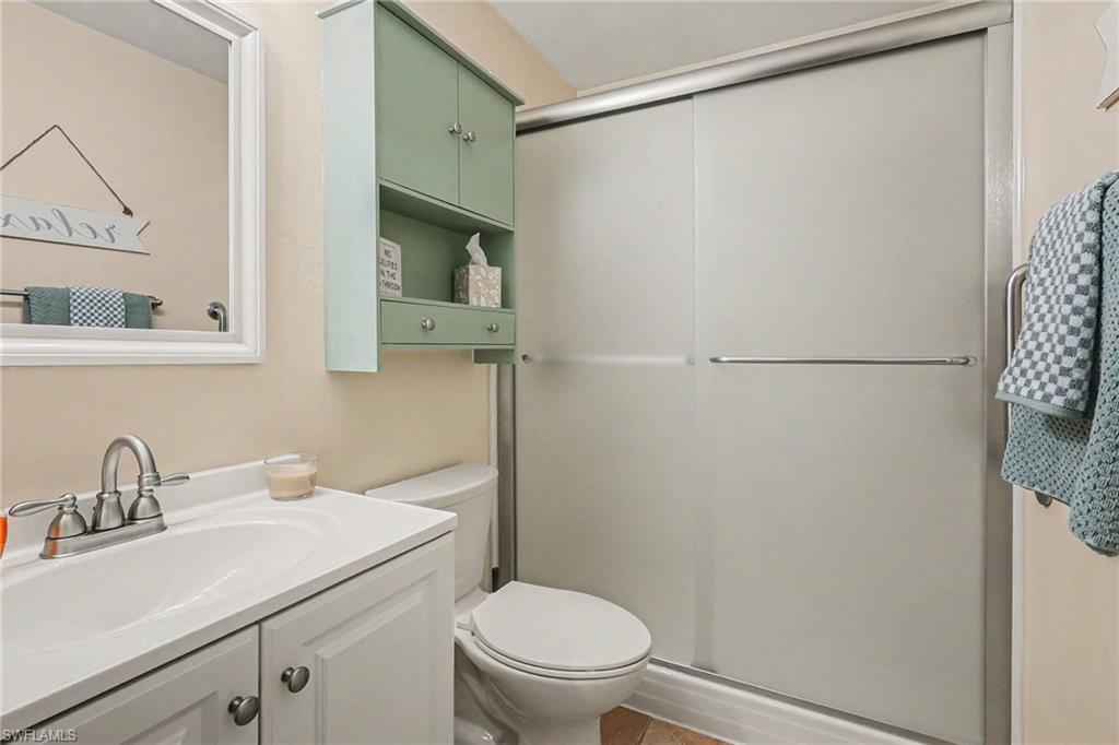 Full bathroom featuring vanity and a shower stall