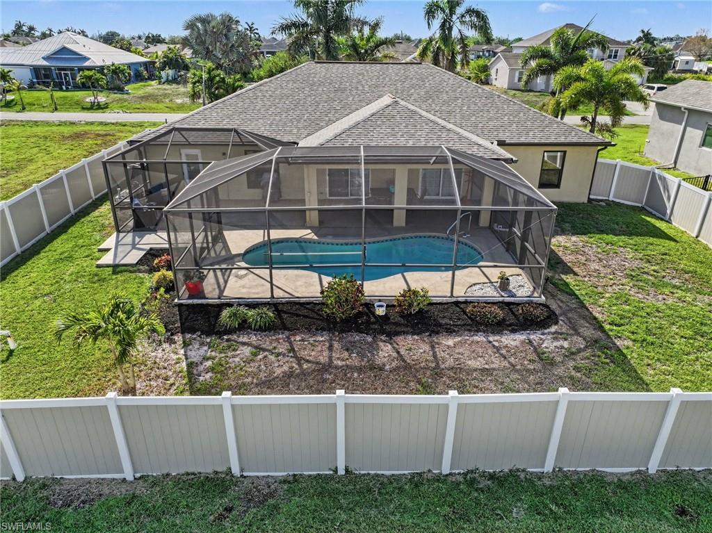 View of swimming pool featuring a fenced backyard, a lanai, a sunroom, and a residential view