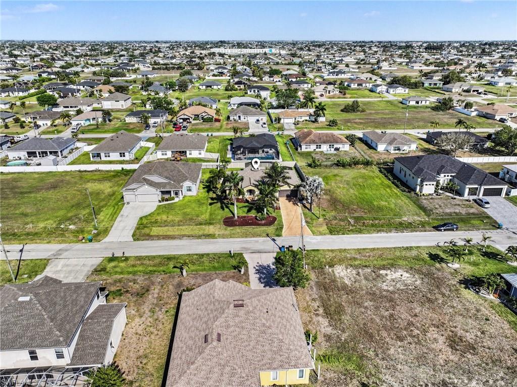 Aerial view of property's location featuring nearby suburban area