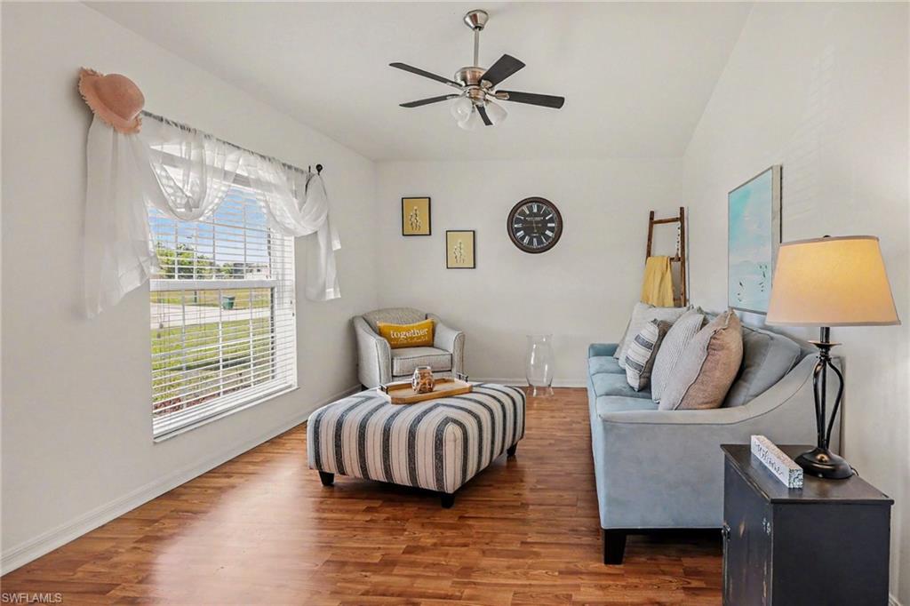 Living room featuring wood finished floors and a ceiling fan