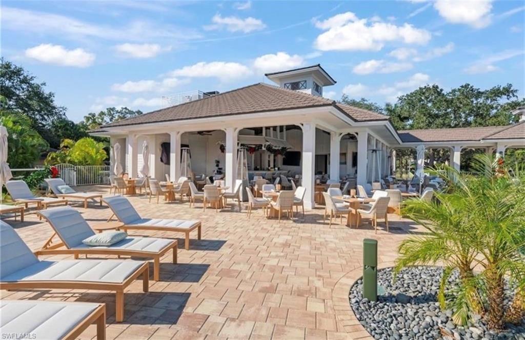 Back of property with a patio area, ceiling fan, and an outdoor living space