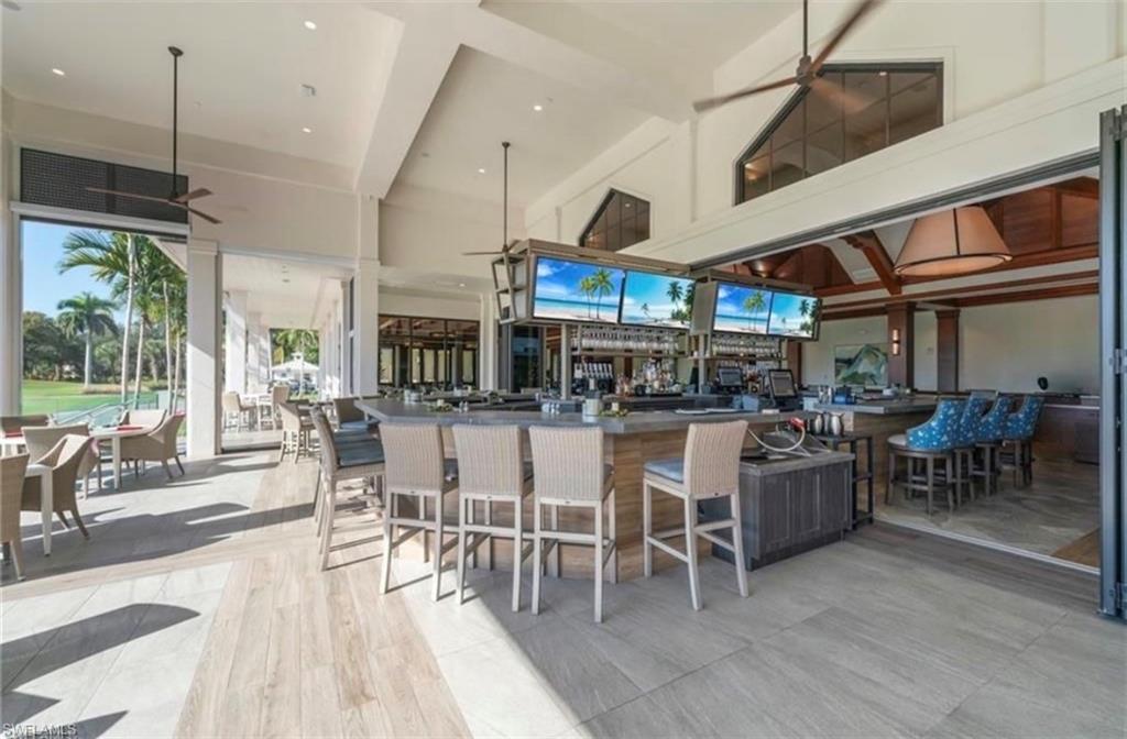 Bar area with ceiling fan, recessed lighting, and dark countertops