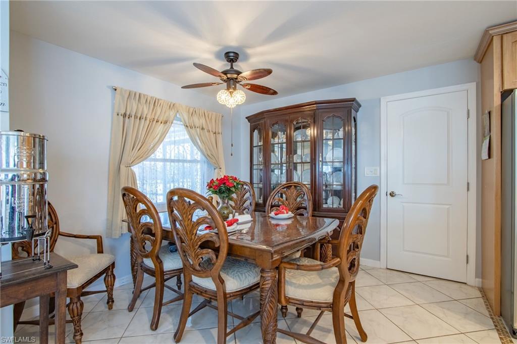Dining room featuring ceiling fan and baseboards